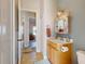 Bathroom featuring a wooden vanity, decorative mirror, and tiled flooring at 905 Maple St, New Smyrna Beach, FL 32169