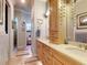 This bathroom has a dual sink vanity with framed mirrors and a view into the attached water closet and shower at 905 Maple St, New Smyrna Beach, FL 32169