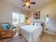 Bedroom with a ceiling fan, a large window, and a comfortable queen size bed at 905 Maple St, New Smyrna Beach, FL 32169