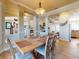 Bright dining room featuring neutral walls, wood floors, stylish furniture, and ample natural light at 905 Maple St, New Smyrna Beach, FL 32169