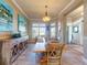 Dining area with neutral walls, wood floors, stylish furniture, and an artistic buffet cabinet at 905 Maple St, New Smyrna Beach, FL 32169