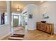 Elegant foyer showcasing hardwood floors, art accents, and an inviting entryway with a wooden cabinet at 905 Maple St, New Smyrna Beach, FL 32169