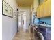 Hallway featuring a side-by-side washer and dryer and ample cabinet storage at 905 Maple St, New Smyrna Beach, FL 32169