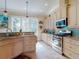 Kitchen showcasing the stainless steel appliances, tile backsplash, and wood cabinets at 905 Maple St, New Smyrna Beach, FL 32169