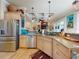 Kitchen with stainless steel appliances, tile backsplash, and views into the living area at 905 Maple St, New Smyrna Beach, FL 32169