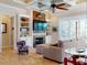 Inviting living room with a fireplace, built-in shelving, and sliding doors to the backyard at 905 Maple St, New Smyrna Beach, FL 32169