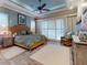 Spacious main bedroom featuring a decorative ceiling, plantation shutters, and stylish furnishings at 905 Maple St, New Smyrna Beach, FL 32169