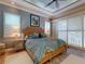 Comfortable main bedroom with natural light, a decorative ceiling fan, and stylish bamboo-style furniture at 905 Maple St, New Smyrna Beach, FL 32169