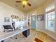 Bright office with neutral walls, wood floors, modern furnishings, and a view of a porch at 905 Maple St, New Smyrna Beach, FL 32169