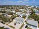 Expansive aerial view of a neighborhood showcasing various homes, palm trees, and the ocean in the distance at 910 Maple St # A & B, New Smyrna Beach, FL 32169