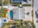 Overhead aerial view of the home showcases the pool area, driveway, and landscaping at 910 Maple St # A & B, New Smyrna Beach, FL 32169