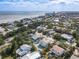 Aerial view of a coastal neighborhood featuring lush greenery, residential homes, and the ocean nearby at 910 Maple St # A & B, New Smyrna Beach, FL 32169