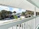 Spacious balcony overlooks a quiet street with mature palm trees at 910 Maple St # A & B, New Smyrna Beach, FL 32169