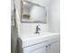 Charming bathroom with a decorative mirror, white subway tile backsplash and a white vanity at 910 Maple St # A & B, New Smyrna Beach, FL 32169