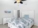 Comfortable bedroom with a ceiling fan, dresser and charming beach-themed art at 910 Maple St # A & B, New Smyrna Beach, FL 32169