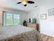 Bedroom with door to balcony, ceiling fan, and mounted TV at 910 Maple St # A & B, New Smyrna Beach, FL 32169