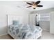 Cozy bedroom featuring a ceiling fan, closet, and natural light from the window at 910 Maple St # A & B, New Smyrna Beach, FL 32169