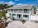 Charming two-story duplex with a balcony, featuring a well-maintained front yard and a light blue exterior at 910 Maple St # A & B, New Smyrna Beach, FL 32169