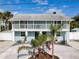 Two-story home featuring a spacious balcony, well-maintained landscaping, and a white picket fence at 910 Maple St # A & B, New Smyrna Beach, FL 32169