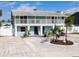 Light blue, two-story duplex showcasing its dual balconies and a landscaped front yard with white gravel at 910 Maple St # A & B, New Smyrna Beach, FL 32169