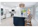 Eat-in kitchen featuring an island with seating, modern lighting and white countertops at 910 Maple St # A & B, New Smyrna Beach, FL 32169