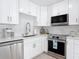 Bright kitchen with stainless steel appliances, white cabinets, countertops and a subway tile backsplash at 910 Maple St # A & B, New Smyrna Beach, FL 32169