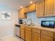 Close up of the kitchen sink with stainless steel appliances, marble backsplash and wood cabinetry at 910 Maple St # A & B, New Smyrna Beach, FL 32169