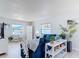 Bright living room featuring a comfortable blue sofa, white floors, and a small desk by the window at 910 Maple St # A & B, New Smyrna Beach, FL 32169