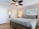 This main bedroom features a ceiling fan, a mirror, and a window that allows natural light to enter at 910 Maple St # A & B, New Smyrna Beach, FL 32169