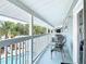 Relaxing covered outdoor patio area with chairs overlooking the pool and lush greenery at 910 Maple St # A & B, New Smyrna Beach, FL 32169