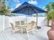 Outdoor patio area features a table with seating and an umbrella for shade at 910 Maple St # A & B, New Smyrna Beach, FL 32169