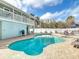 Inviting backyard features a sparkling pool, jacuzzi and outdoor kitchen area at 910 Maple St # A & B, New Smyrna Beach, FL 32169