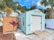 A shed for storage on the side of the home has a roll-up door and an adjacent fenced area at 910 Maple St # A & B, New Smyrna Beach, FL 32169