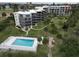 A beautiful building aerial view features a pool, landscaping and easy access to the beach in New Smyrna Beach, Florida at 944 S Peninsula Dr # 5010, Daytona Beach, FL 32118