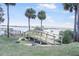 Beautiful backyard featuring a wooden bridge, palm trees, and a serene waterfront view at 944 S Peninsula Dr # 5010, Daytona Beach, FL 32118