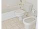 This full bathroom features a toilet, bidet, and tub with tile flooring at 944 S Peninsula Dr # 5010, Daytona Beach, FL 32118