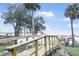 Waterfront boardwalk overlooking the water with a bridge in the background and beautiful, lush palm trees at 944 S Peninsula Dr # 5010, Daytona Beach, FL 32118