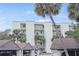 Condominium exterior with carports surrounded by tropical palm trees and well-maintained landscaping at 944 S Peninsula Dr # 5010, Daytona Beach, FL 32118