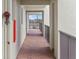 Well-lit hallway featuring brick floors and an open-air walkway with views of surrounding greenery at 944 S Peninsula Dr # 5010, Daytona Beach, FL 32118