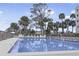 Inviting pool area with lounge chairs and palm trees, perfect for relaxation at 944 S Peninsula Dr # 5010, Daytona Beach, FL 32118