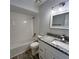 Well-lit bathroom featuring subway tile shower and granite countertop sink at 956 Tall Pine Dr, Port Orange, FL 32127