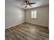 Cozy bedroom with ceiling fan, window, and wood-look flooring at 956 Tall Pine Dr, Port Orange, FL 32127