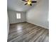 Spacious bedroom with modern ceiling fan, wood floors, and bright window at 956 Tall Pine Dr, Port Orange, FL 32127