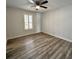 Bedroom features window, ceiling fan, and light grey wood-look flooring at 956 Tall Pine Dr, Port Orange, FL 32127