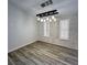 Charming dining room featuring wood floors, exposed brick, and a modern chandelier at 956 Tall Pine Dr, Port Orange, FL 32127