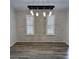 Dining area with modern hanging light fixture, plantation shutters, and gray flooring at 956 Tall Pine Dr, Port Orange, FL 32127