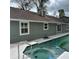 Backyard pool with a spa and a charming house in the background at 956 Tall Pine Dr, Port Orange, FL 32127