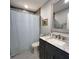 Bathroom featuring a shower with a curtain, vanity, and decorative mirror, maximizing the space at 2380 Captain Butler Trl, New Smyrna Beach, FL 32168