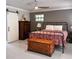 Bedroom featuring a wrought iron bed, chest, side tables, and a door that leads to the bathroom at 2380 Captain Butler Trl, New Smyrna Beach, FL 32168