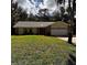 Attractive single-story home with a two-car garage, stone accents, and a well-maintained lawn at 2380 Captain Butler Trl, New Smyrna Beach, FL 32168